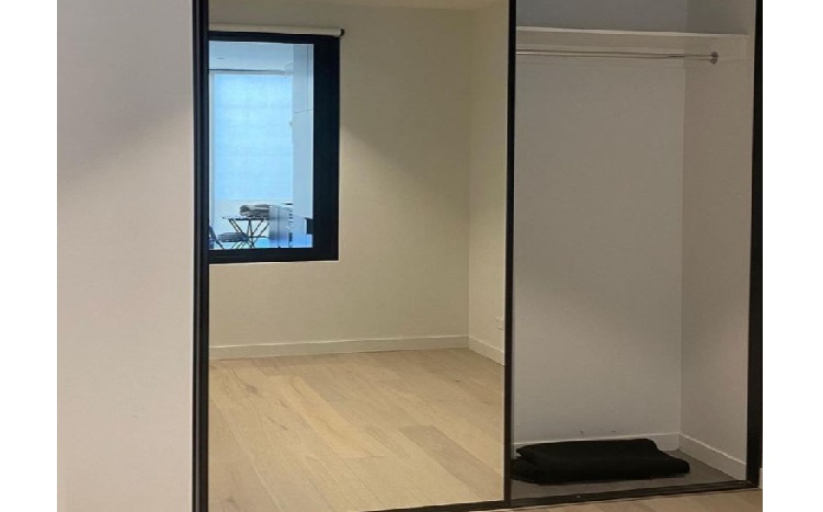 Interior renovation area with wardrobe opening and light flooring